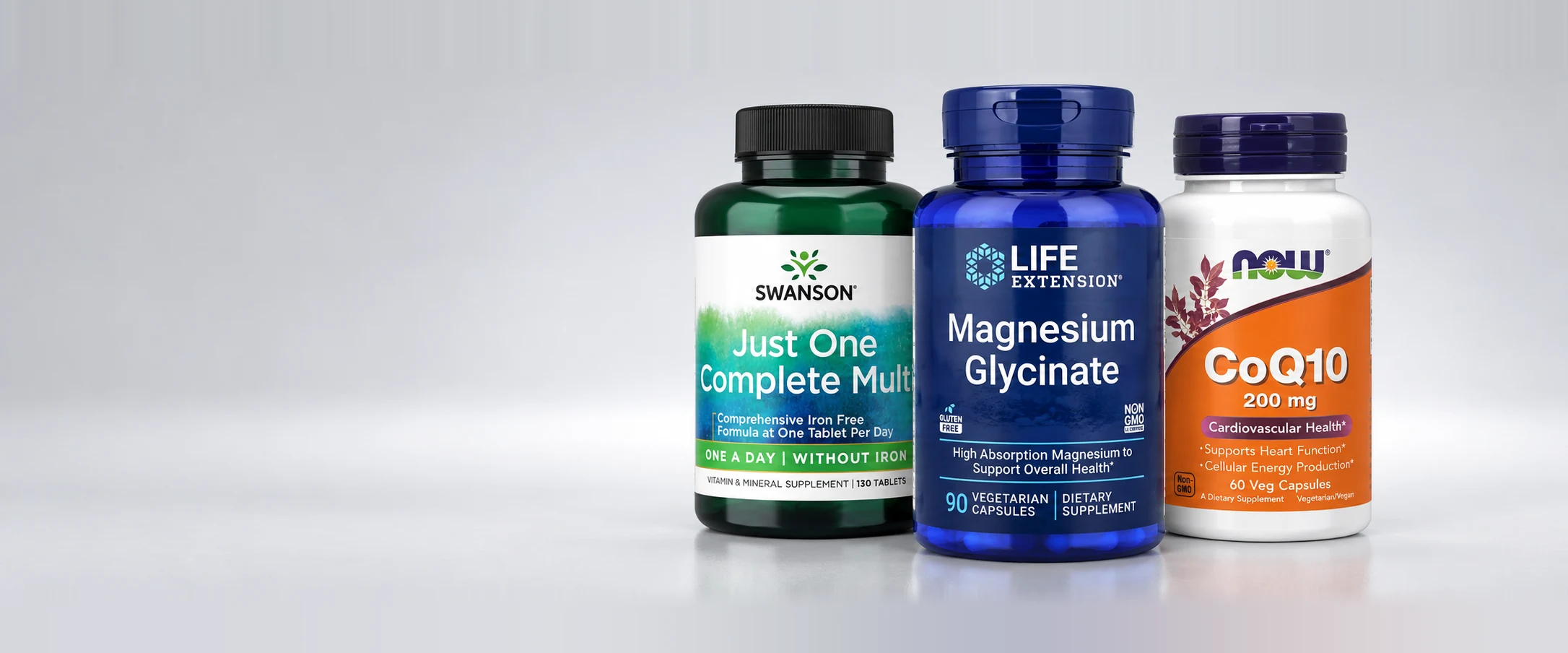 Swanson Just One Complete Multi, Life Extension Magnesium Glycinate and NOW CoQ10 200 mg bottles on a light grey background